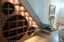 20 a creative and cool modern wine rack under the stairs with additional lights to accent it