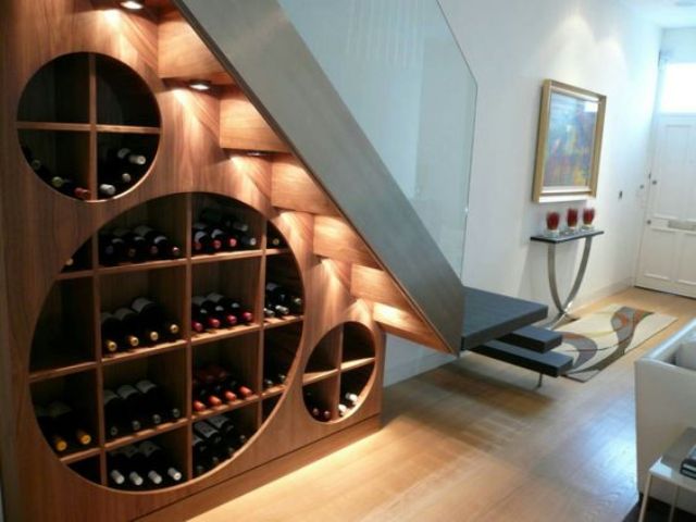 a creative and cool modern wine rack under the stairs with additional lights to accent it