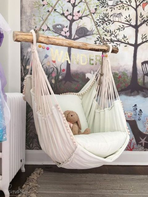 a hammock chair with cushions is a great piece for a kids' room to make it welcoming and dreamy