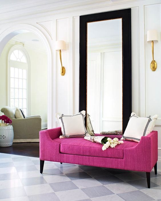 a very elegant entryway with a bright magenta bench, which adds cheer and color