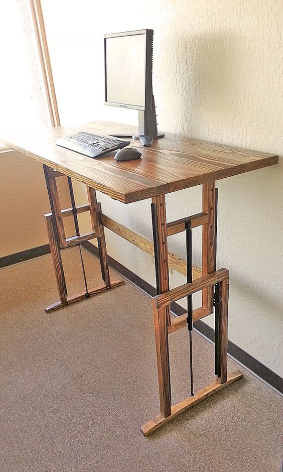 an adjustable wooden desk is a great idea to sit and stand anytime you want