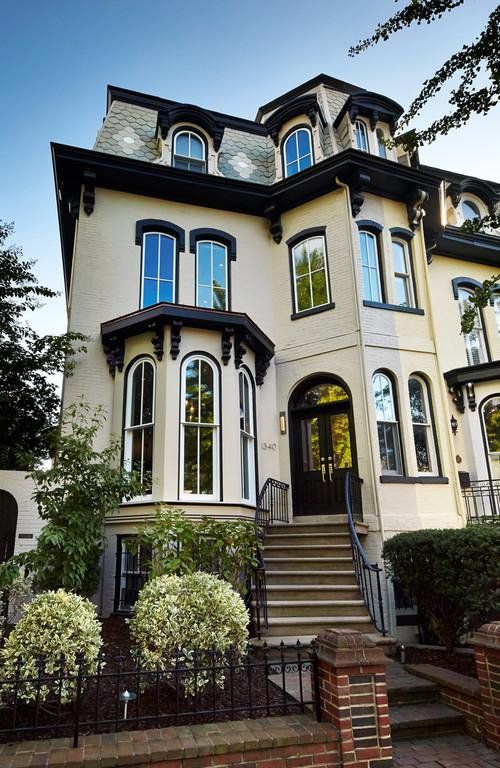 a Victorian-inspired house in black and white with a chic embellished mansard roof