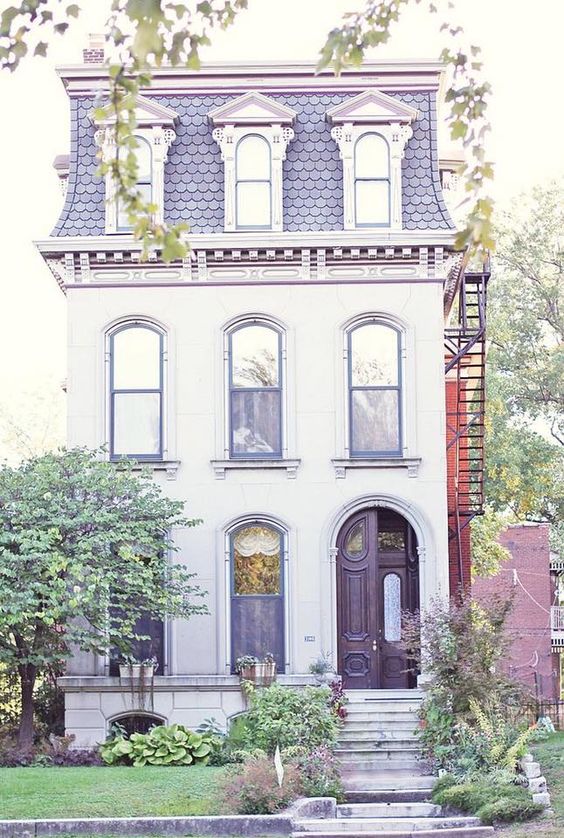 a small footprint yet tall home with a mansard roof, which becomes another floor for living