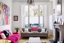 23 an eclectic space with a magenta sofa and a matching bright artwork for a colorful statement