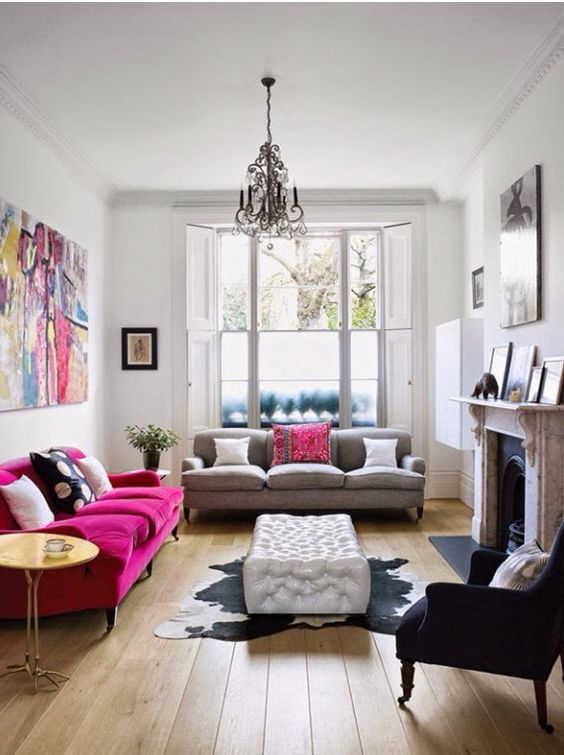 An eclectic space with a magenta sofa and a matching bright artwork for a colorful statement