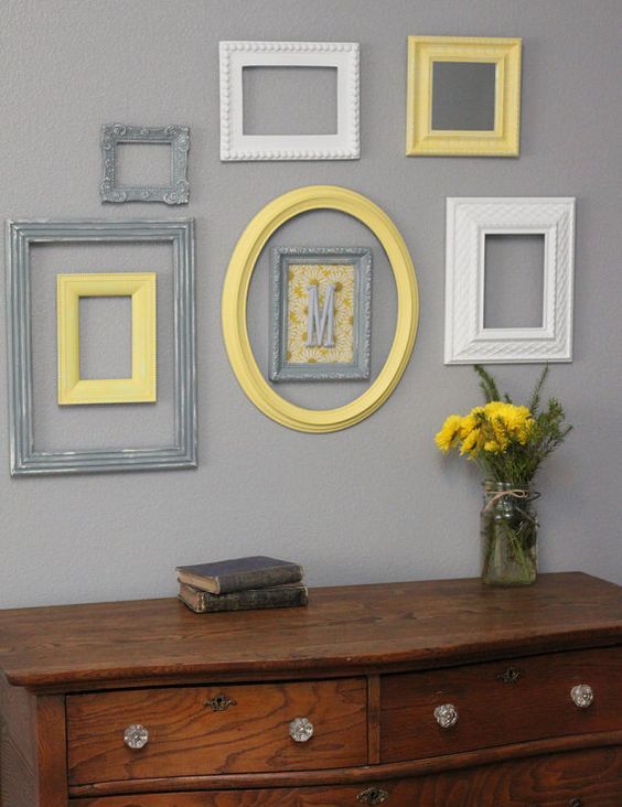 vintage rustic decor is highlighted with a group of frames in yellow, grey and white plus a monogram