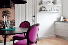 24 a chic dining space with elegant magenta chairs and floral wallpaper to separate it from the kitchen