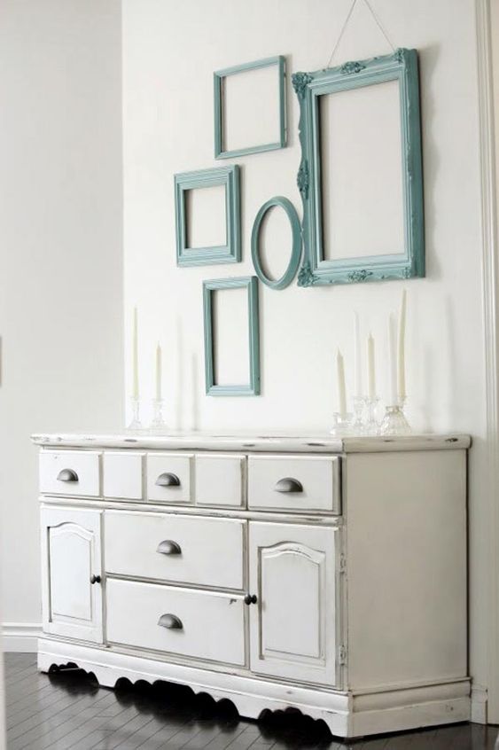A neutral shabby chic space is injected with color using aqua painted frames on the wall