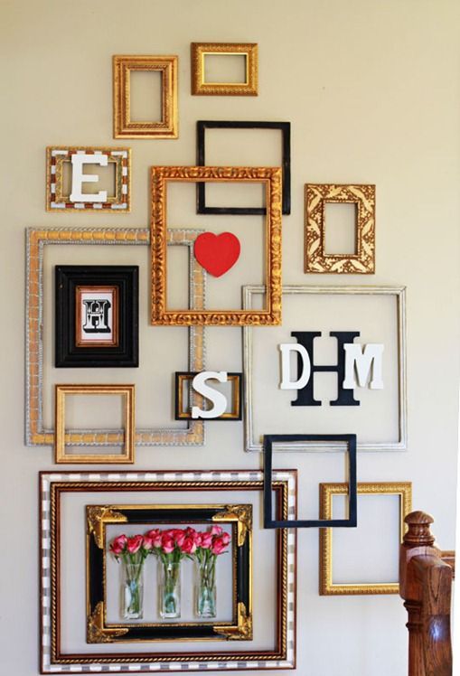 a super creative gallery wall using empty frames, monograms and even blooms in vases