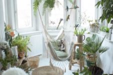 25 an awkward nook filled with potted greenery and a hammock chair is a great idea to use dead space
