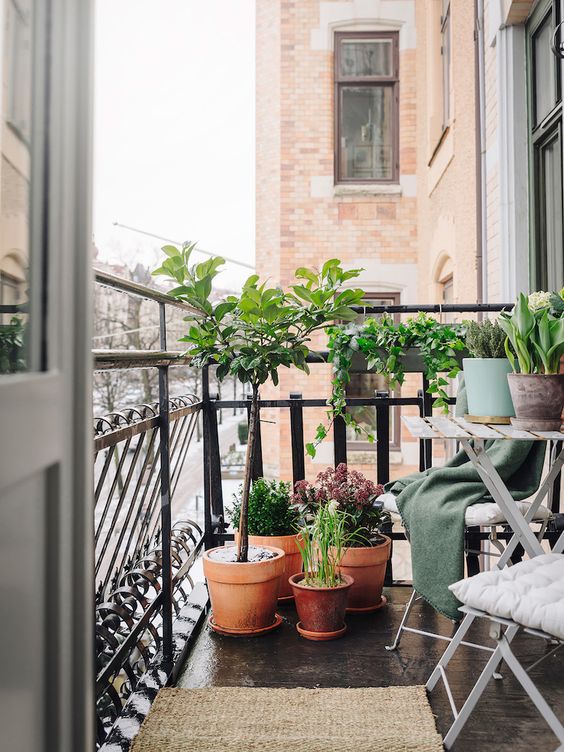 folding furniture and potted greenery are all you need for a small balcony