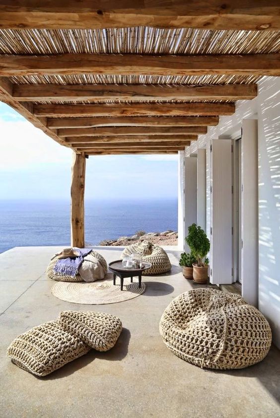 super cool straw bean bag chairs and floor pillows to create a chic Mediterrnean lounge outdoors