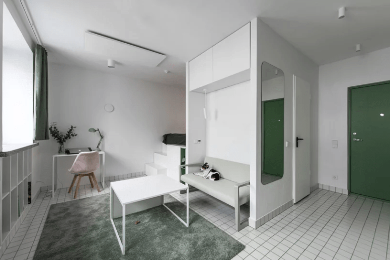 This tiny minimalist apartment features everything necessary for living and is done with old touches of green