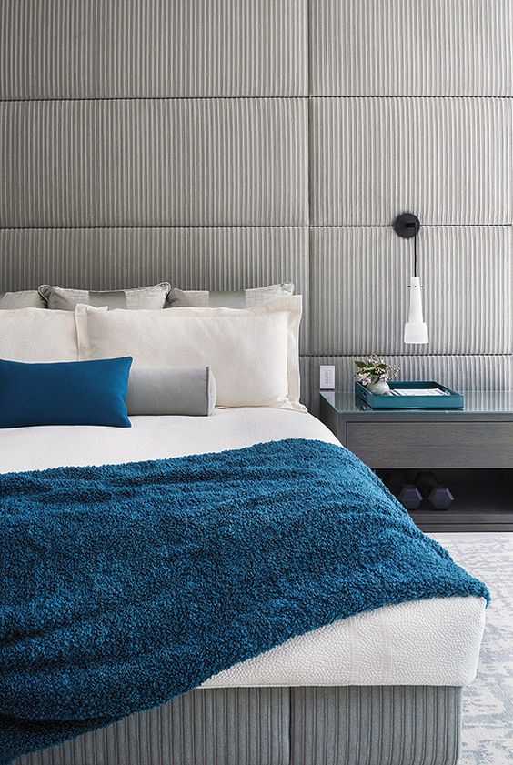 a grey bedroom with touches of blue and teal for a modern and a bit contrasting look