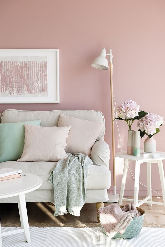a pastel living room with much neutrals, pink and some mint-colored accents