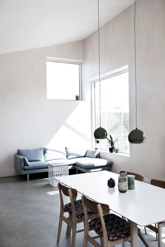 The living space is also here, with a blue sofa by the window to catch more sunlight