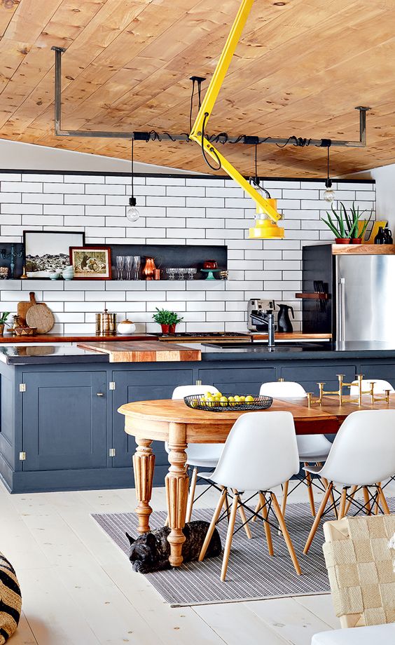 a kitchen island separates the kitchen and the dining space