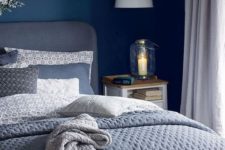 03 a relaxing bedroom with grey as a dominant color and navy as a bold accent one