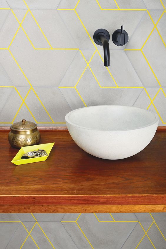 An ultra modern bathroom look with geometric matte grey tiles and neon yellow grout