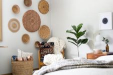 some wicker baskets on the wall, a basket for storage, tassels and chunky knit for a boho bedroom