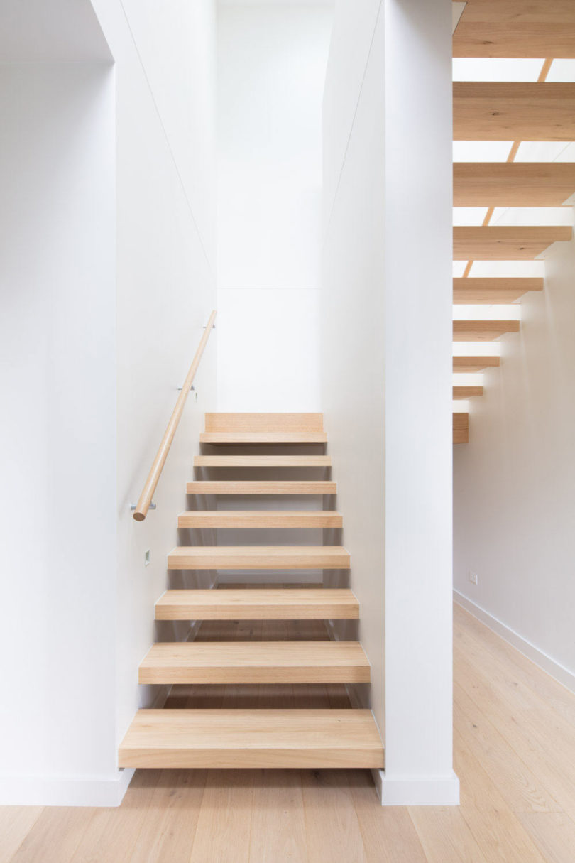 The stairs are floating ones, done of light colored wood
