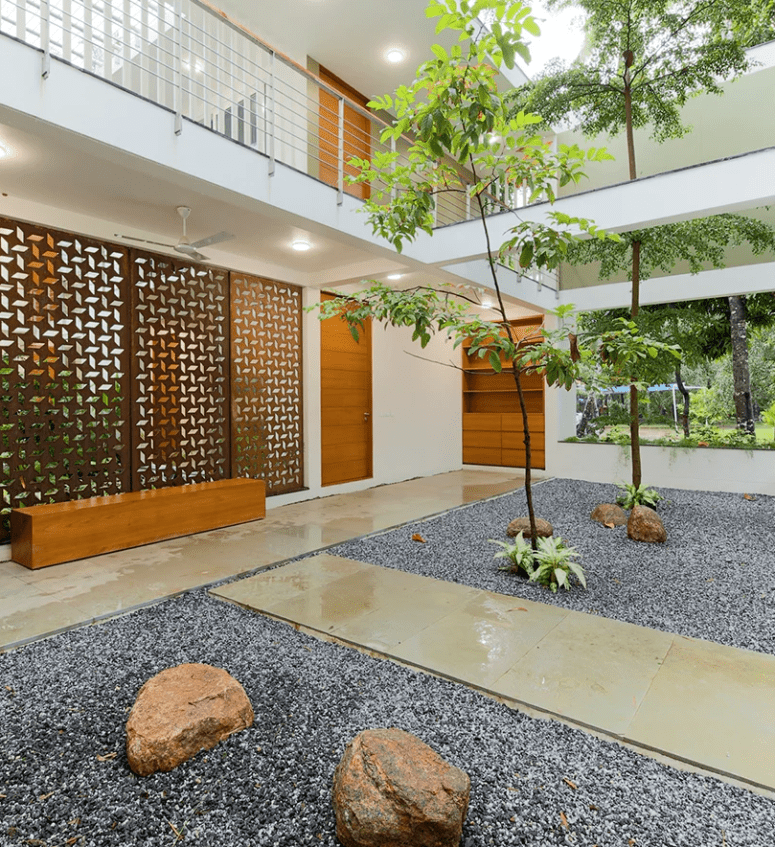 The two halves of the building are connected with an inner courtyard with stones and trees growing
