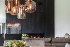 04 a fireplace clad with dark wooden panels makes up the coolest statement in this neutral space