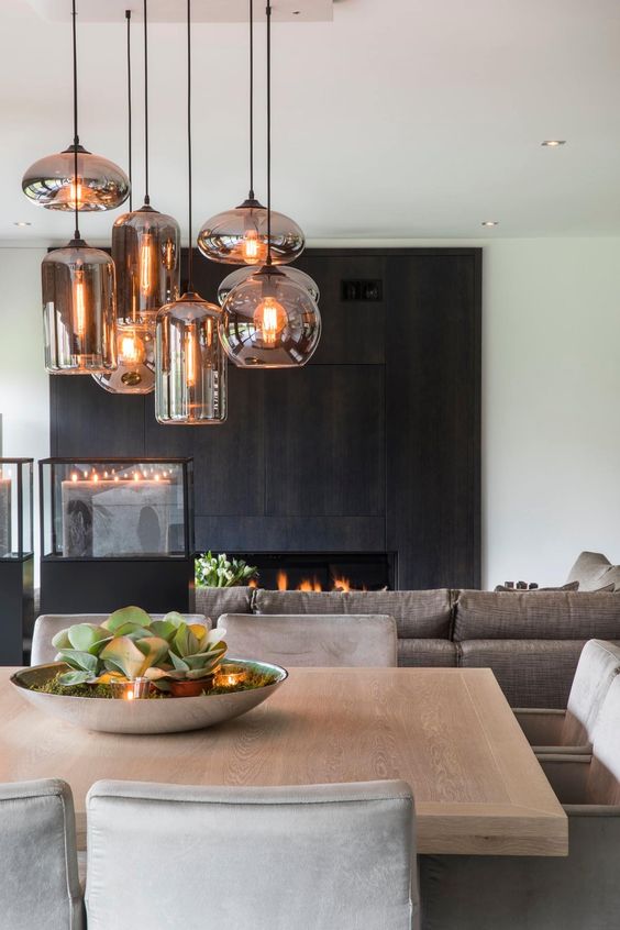 a fireplace clad with dark wooden panels makes up the coolest statement in this neutral space