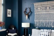 04 deep blue walls can be refreshed with various white accents like a macrame hanging and a yarn lampshade