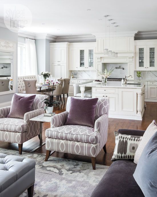 purple velvet chairs separate the living room and the kitchen and dining space