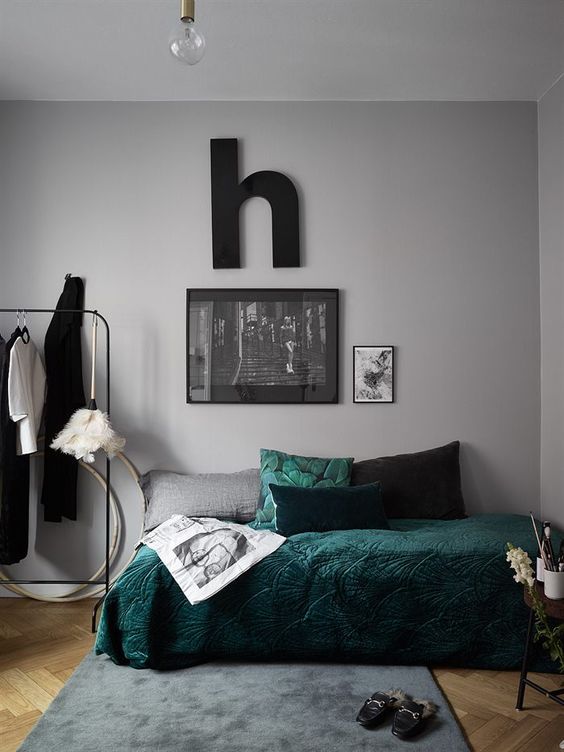Spruce up with grey bedroom with touches of dark green like here   a pillow and a bedspread