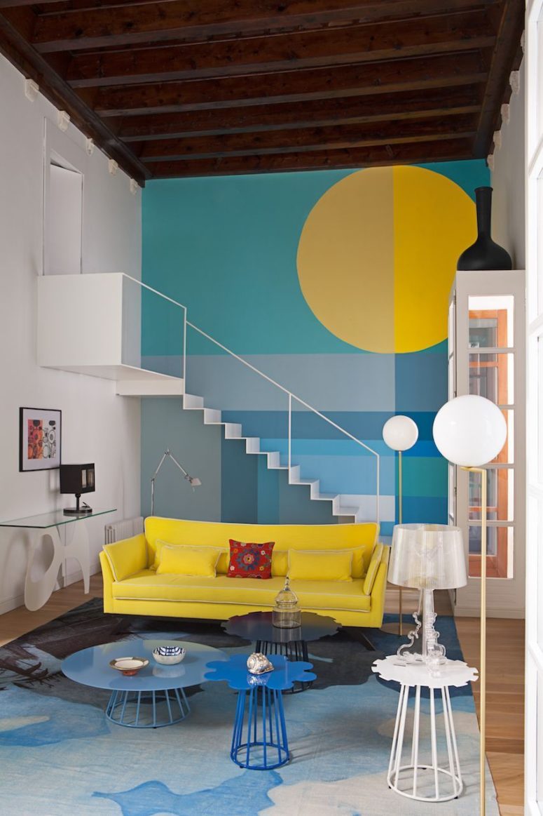 The living room is a vibrant space done in the shades of blue and yellow