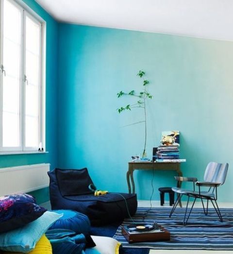 a bright living room with light blue as a dominant color and navy as an additional one