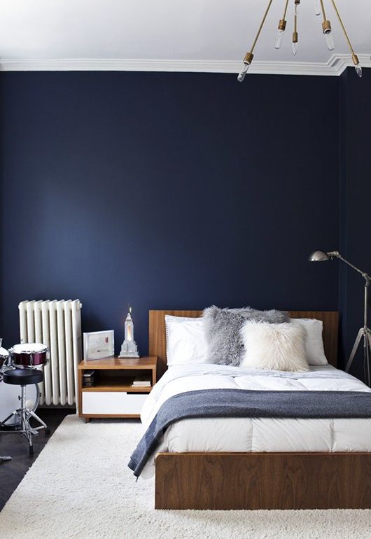 a navy statement wall takes over the space and makes it welcoming and relaxing