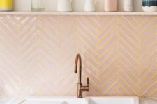 05 blush tiles clad in a chevron pattern and spruced up with sunny yellow grout for a modern backsplash