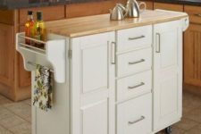 06 a comfy mobile kitchen island with many drawers and holders plus a wooden countertop