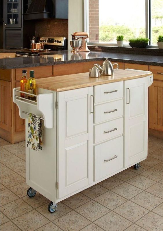 a comfy mobile kitchen island with many drawers and holders plus a wooden countertop