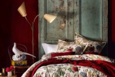 06 a deep red statement wall and a matching bedspread add color and interest to the room