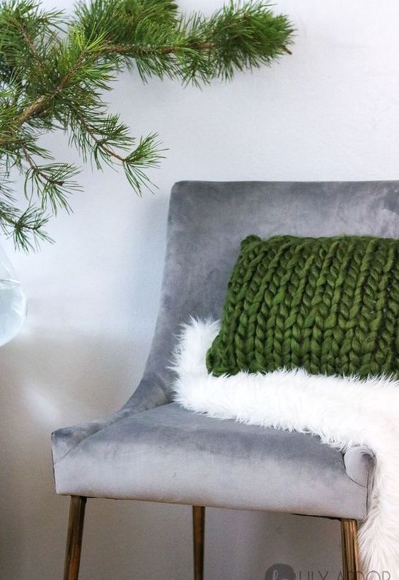 a faux fur throw and a chunky knit pillow add texture and coziness to the space