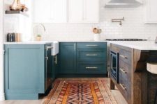 06 a two-toned kitchen in teal and white plus a dark-stained kitchen island to add a rustic touch