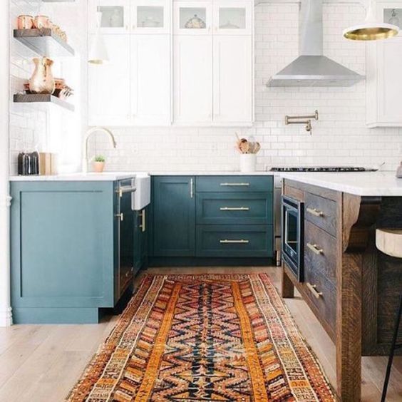 a two-toned kitchen in teal and white plus a dark-stained kitchen island to add a rustic touch
