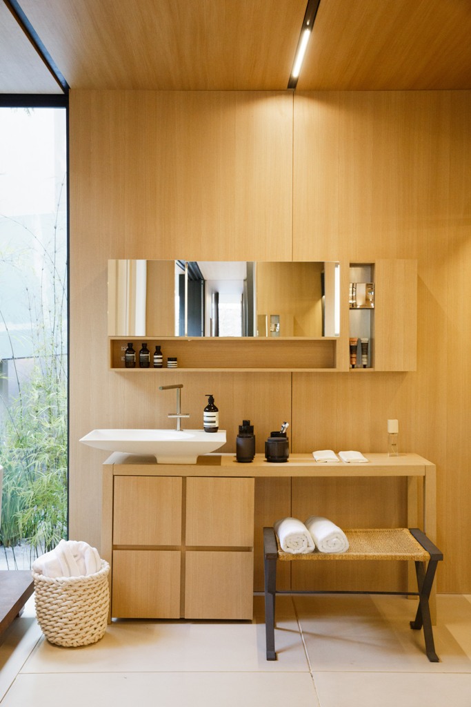 The bathroom features the same materials and comfy furniture with everything necessary