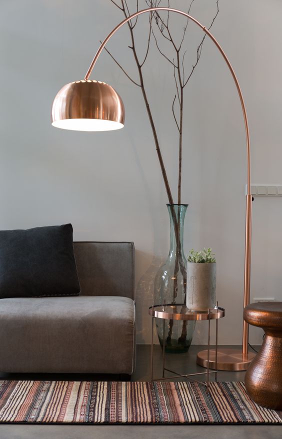 a copper floor lamp with a long leg is sure to make a stylish statement and add a trendy touch with its metallic look