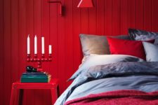 07 a red wooden plank wall, a matching sconce and a nigthstand create a super colorful space