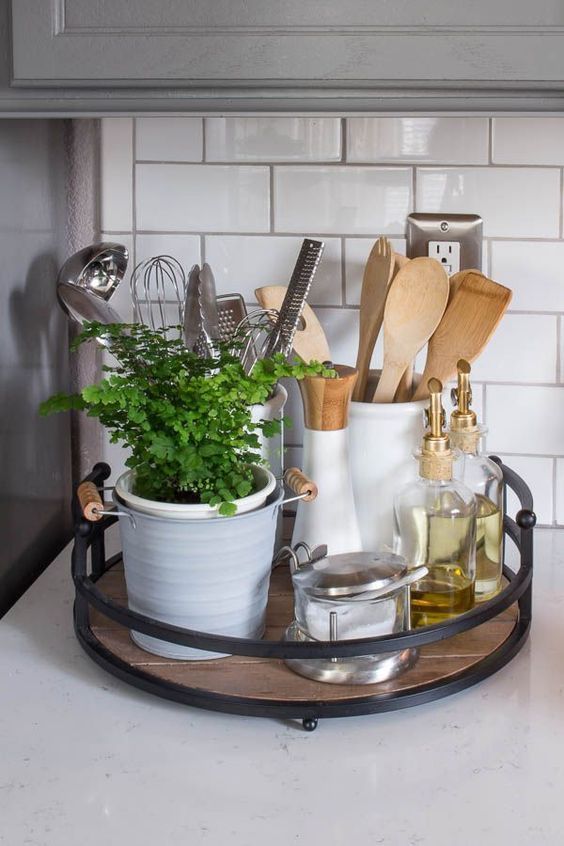 a stylish modern kitchen caddy with black metal framing and a wooden bottom