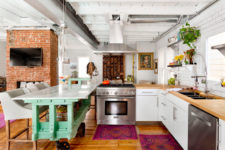 07 bold printed rugs, an aqua kitchen island and some potted greenery for a strong boho feel