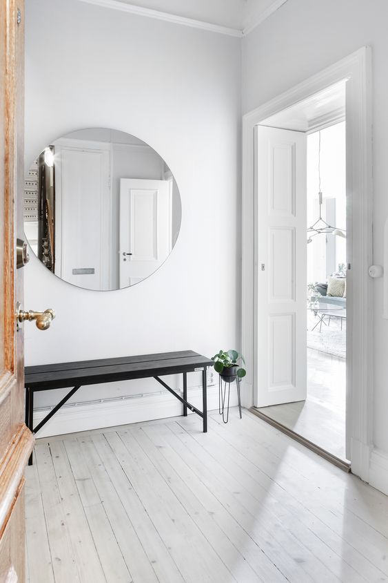 a mirror is a must for an entryway and it makes a space larger, which is essential for a small space