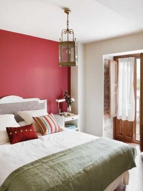 a red statement wall brings color to the space and spruces up the neutrals