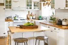 08 a rustic kitchen island with a wooden countertop, on casters and with holders can double as a meal space