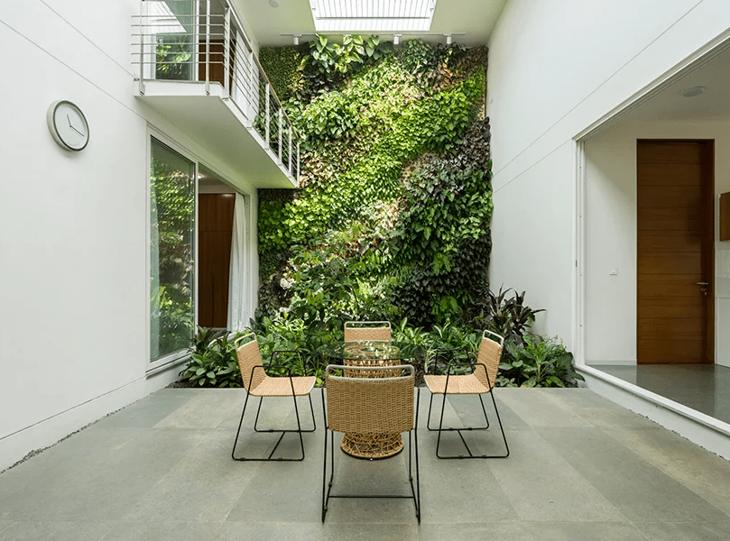 A sheltered patio with a living wall is an ideal place for having meals, it looks very welcoming